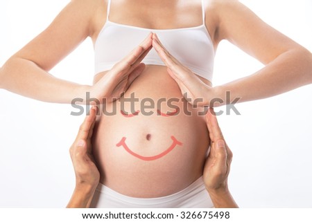 House from hands around pregnant belly