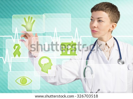 Young female doctor touching icon of media screen