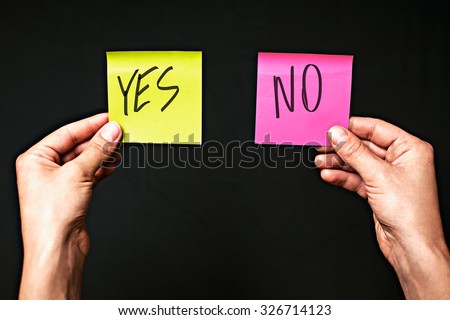 Image of colored stickers isolated on black background with the words yes and no. The concept of making the right choice, make the choice.