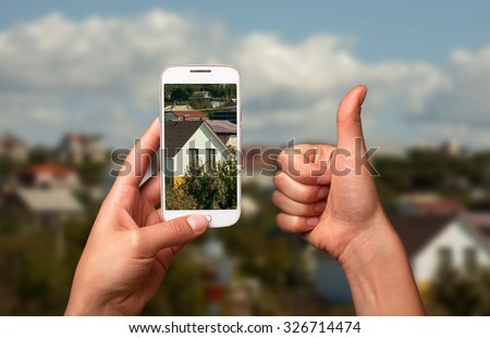Image smartphone photo of a beautiful house. The "Like" and the smart phone, taking pictures of the house. For Sale House.
