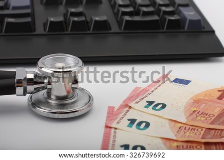 Stethoscope,money, keyboard on white, medical concept.