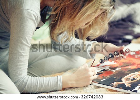 woman draws at home
