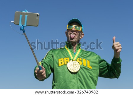 Gold medal athlete in Brazil jacket makes an excited face as he poses for a celebration picture