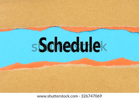 Torn brown and orange paper on blue surface with "Schedule" words.