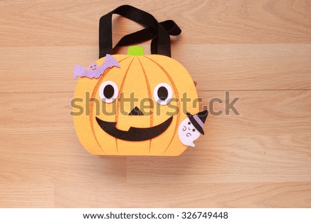 Halloween party bag  pumpkin, bat and ghost. festive halloween elements on wood