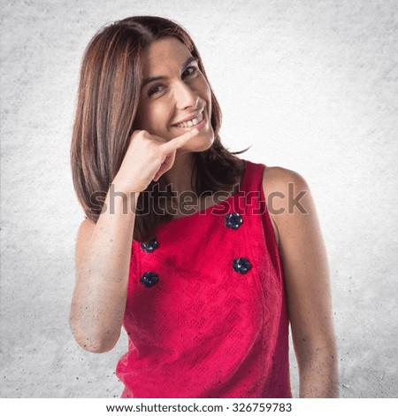 Woman making phone gesture