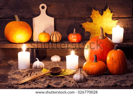 pumpkins on a wooden table with kitchen accessories. studio shot