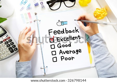  Person drawing Feedback concept on white paper in the office