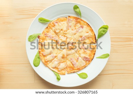 Rustic pizza on wooden background. Top view