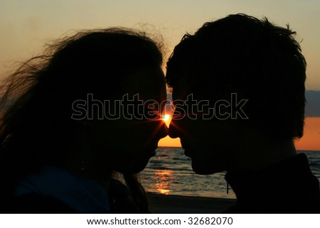 young couple kissing on the coast