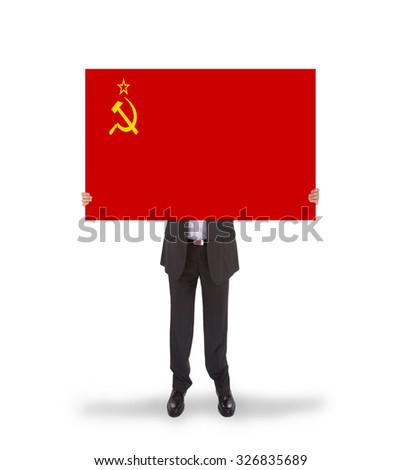 Smiling businessman holding a big card, flag of the USSR, isolated on white