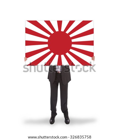 Smiling businessman holding a big card, flag of Japan, isolated on white