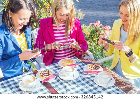 Three friends taking picture of food 