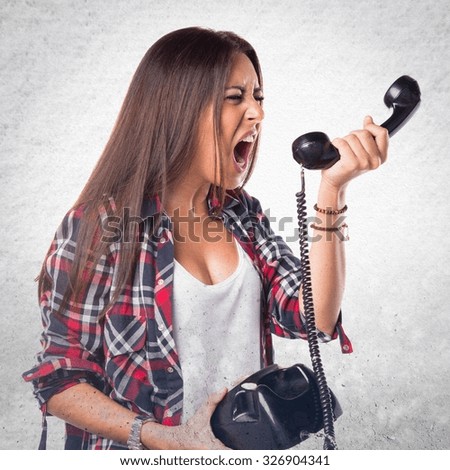 Woman shouting to vintage phone