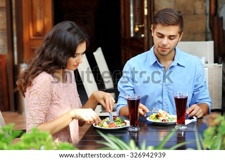 happy couple eating at terrace
