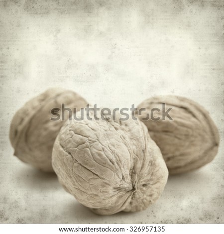 textured old paper background with freshly harvested walnuts