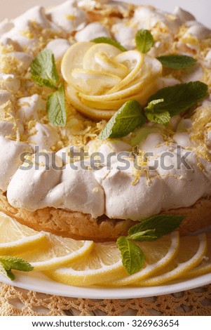 Beautiful lemon cake with meringue on a plate macro. vertical
