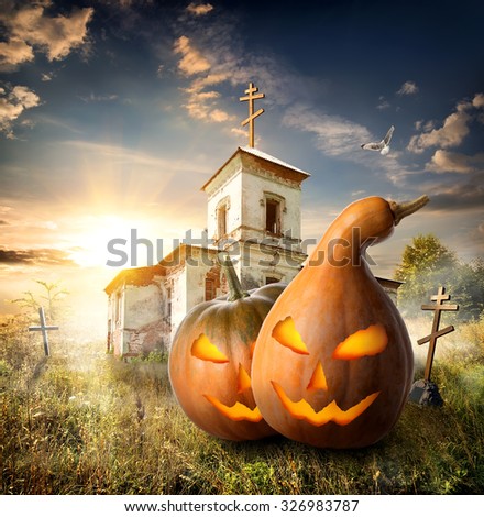 Halloween pumpkins on a churchyard near old church