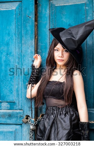 Beautiful Asian woman in witch costume for Halloween concept