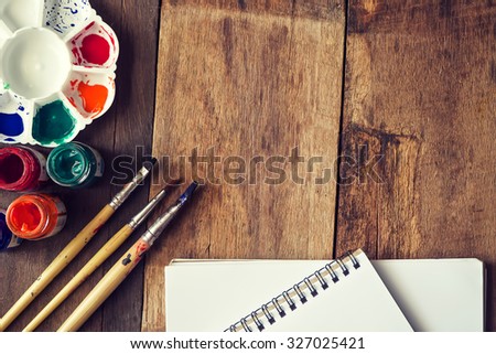 Brush and paper watercolor abstract stains on the wood background