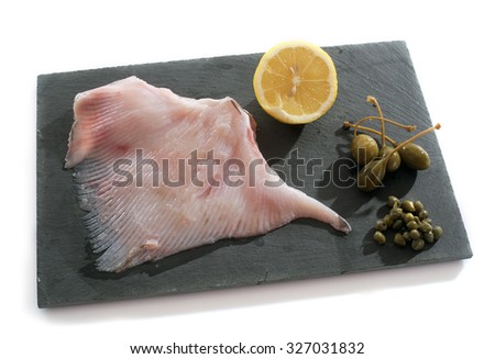 Fresh skate wings in front of white background
