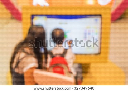 blur image of kids touching on big touch screen  computer.(Mosaic pattern effect image)