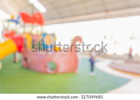 Defocused and blur image of children's playground at public park for background usage.(Mosaic pattern effect image)