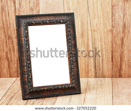 Empty Antique photo frame on a wooden background.
