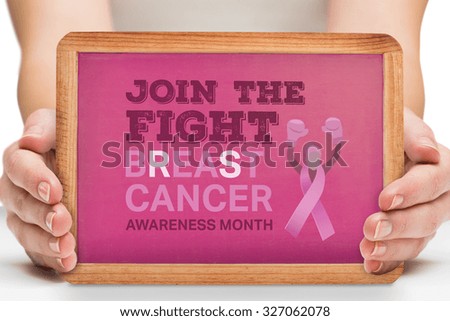 Females hands showing pink board against breast cancer awareness message