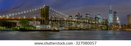 Panoramic view New York City Manhattan downtown skyline at night with skyscrapers 