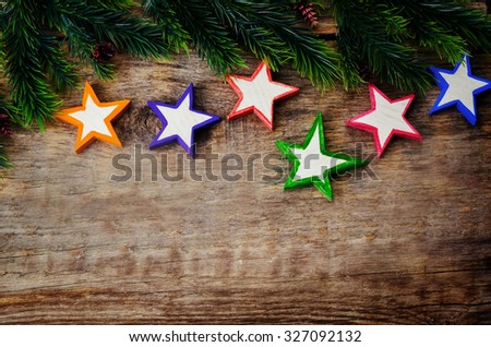wooden background with wooden toys in the shapes of stars and the branches of the Christmas tree for Christmas. toning. selective focus