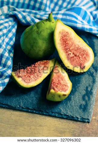 Fig tree fruits on the vintage plate and napkin. Toned picture