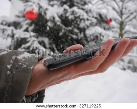 tablet in hand in winter smartphone winter christmas snow