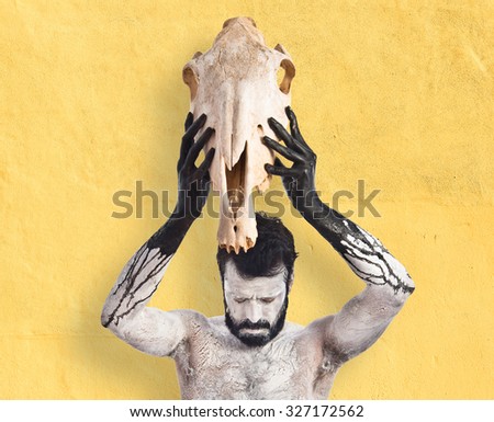 Primitive man offering horse skull