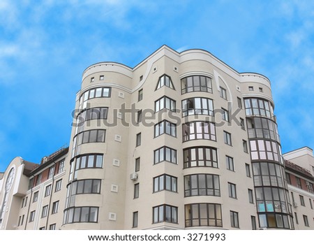 The apartment house photographed in a clear sunny day on a background of the blue sky