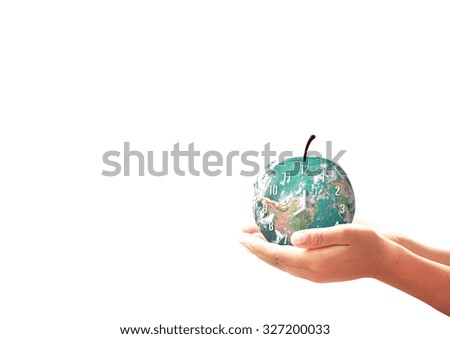 Earth day concept: Clock fruit of earth globe in human hands on white background. Elements of this image furnished by NASA