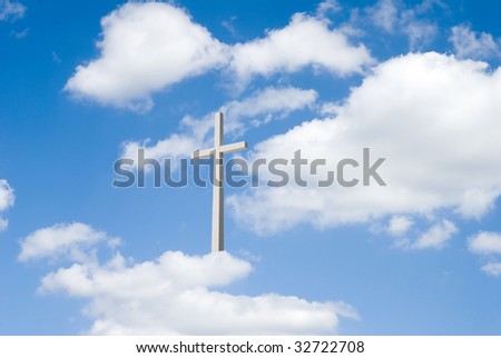 A beautiful partly cloudy blue sky  with religious cross resting on clouds for background