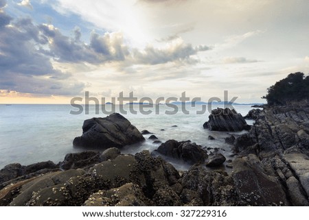 Sunset scenery in Borneo beach with rock formation.