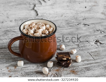 hot chocolate with marshmallows in a ceramic cup on bright wooden surface