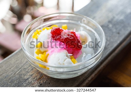 Delicious ice cream coconut milk and Astor berry jam , on color wooden background