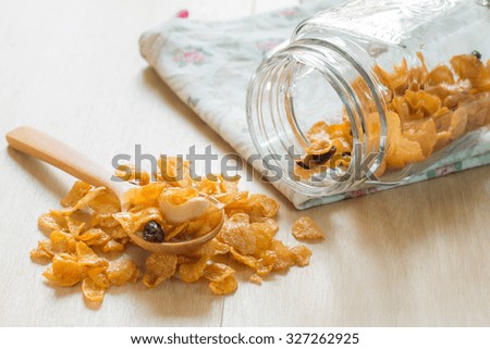 Caramel cornflake in spoon on wooden table,Selective focus on cashew nut.