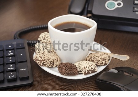 sweets with coffee on office Desk Royalty-Free Stock Photo #327278408