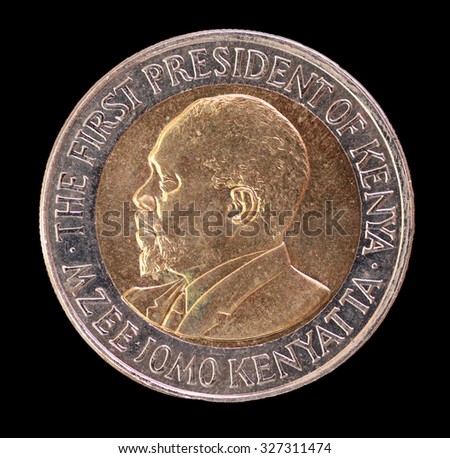 The head face of a 20 shilling coin, issued by the Republic of Kenya in 2005, depicting the portrait of the First President Mzee Jomo Kenyatta. Image isolated on black background