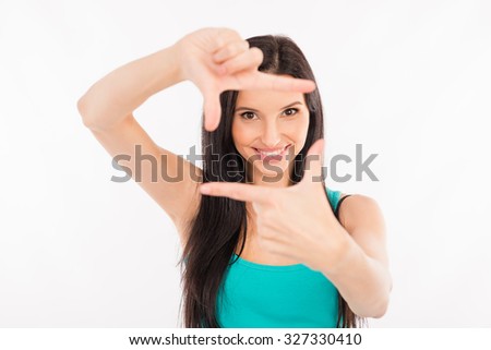 happy young woman gesturing finger frame and smiling