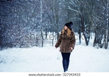 Pretty woman in a winter park