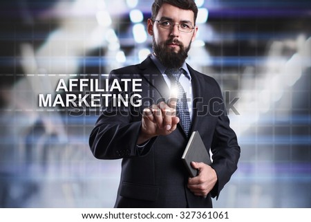 Businessman pressing button on touch screen interface and select affiliate marketing. Business concept. Internet concept.