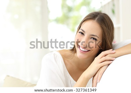 Beauty woman with white perfect smile looking at camera at home Royalty-Free Stock Photo #327361349