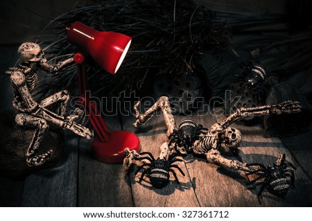 Dark Halloween Concept Skeleton with a Lantern in Halloween Wooden Background Texture