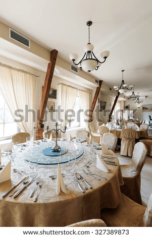 Picture of luxurious tableware in spacious hotel dining area