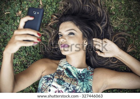 Beautiful girl take a selfie using a mobile phone 